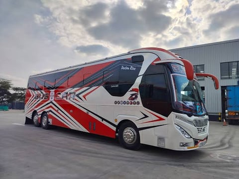 Red and white intercity coach bus at terminal facility